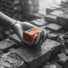 image of hand with brick